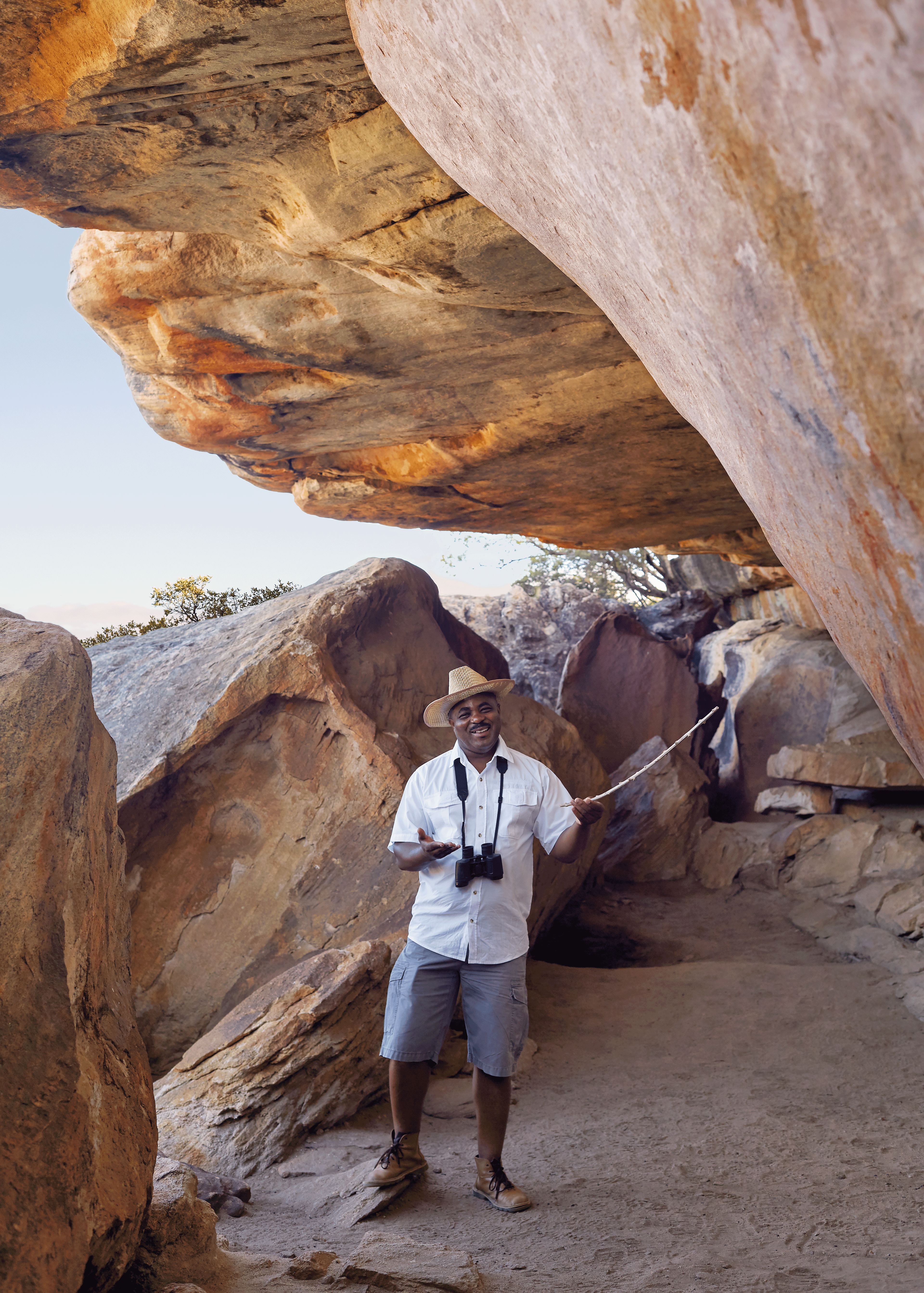 Bushmans Kloof Londi at the Cave pointing to rick art with a stick