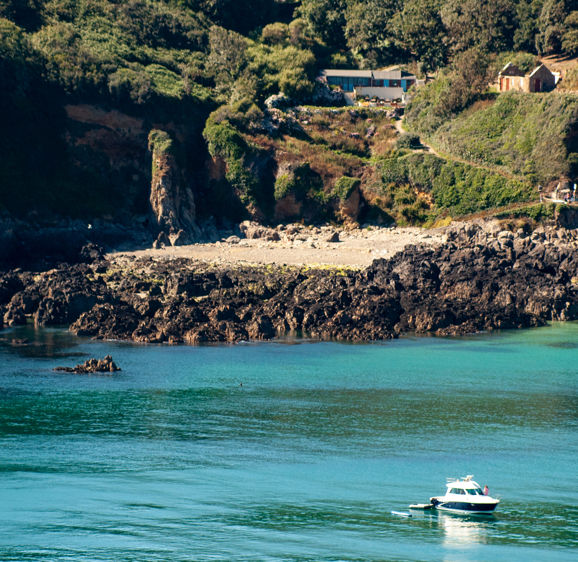Moulin Huet Bay with boat in Guernsey Moulin Huet Bay with boat in Guernsey