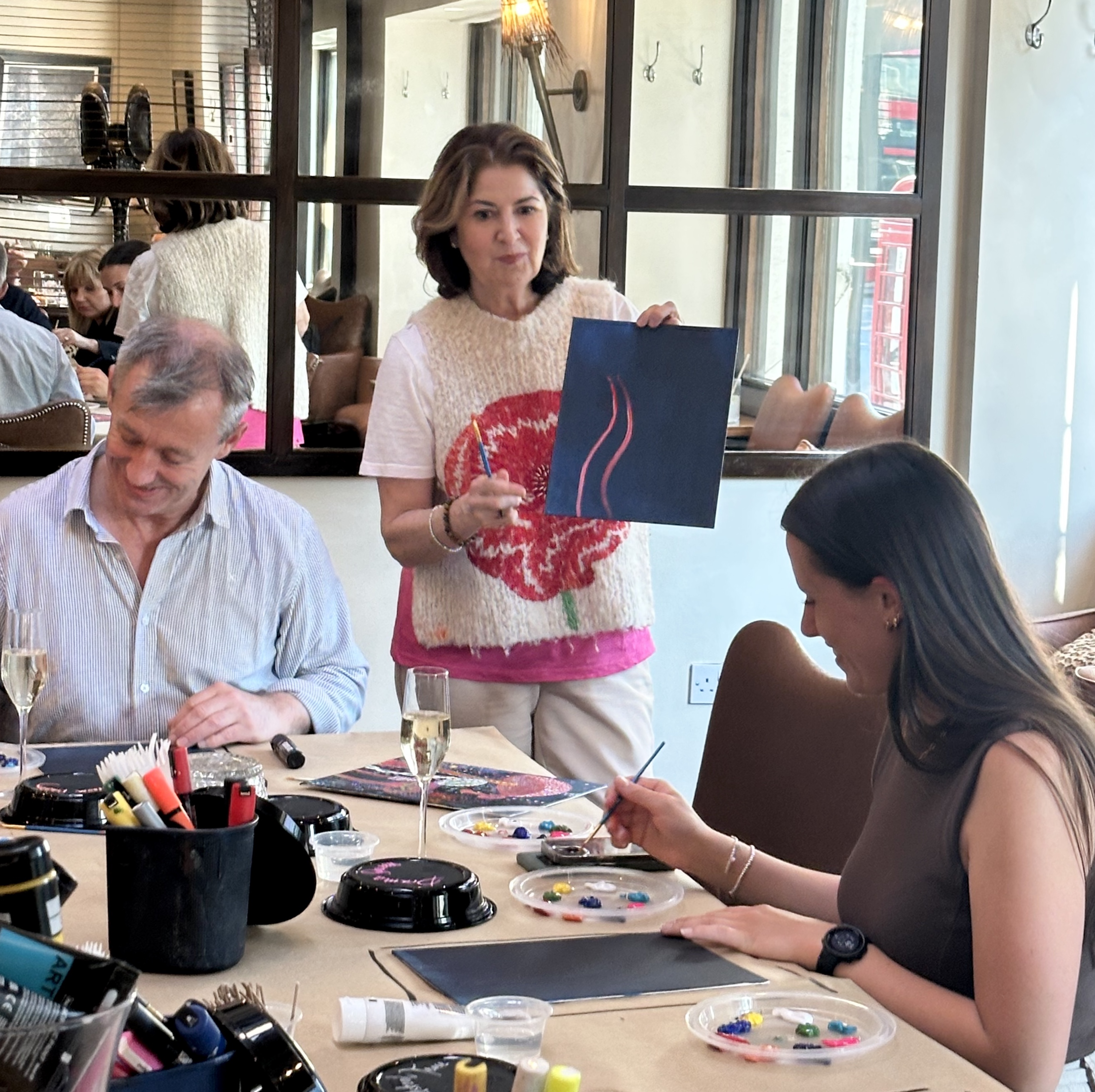 shelley instructing smiling group on what best colours to choose