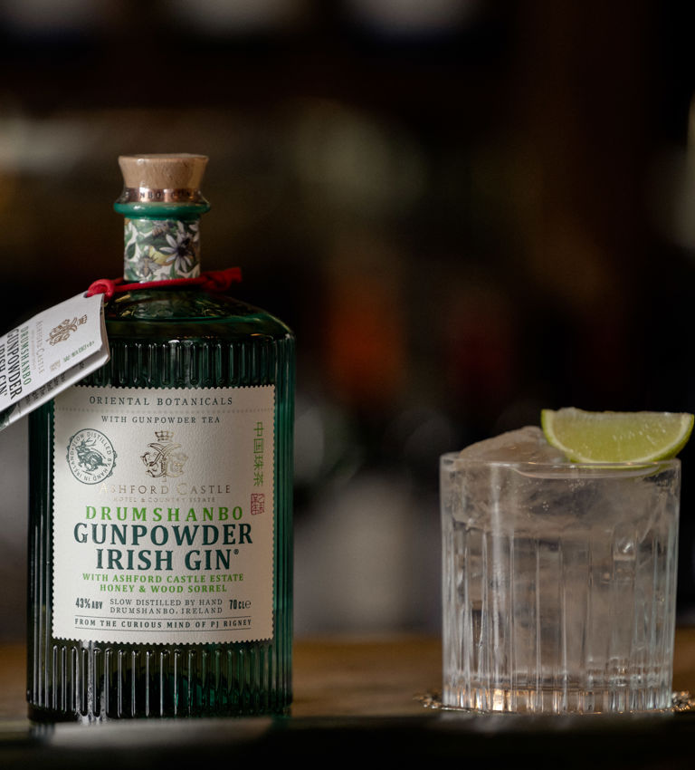 Bottle of Gunpowder Irish Gin along with glass of ice and lime Bottle of Gunpowder Irish Gin along with glass of ice and lime