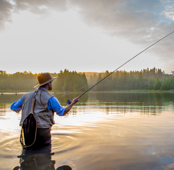 Young man flyfishing at sunrise Young man flyfishing at sunrise