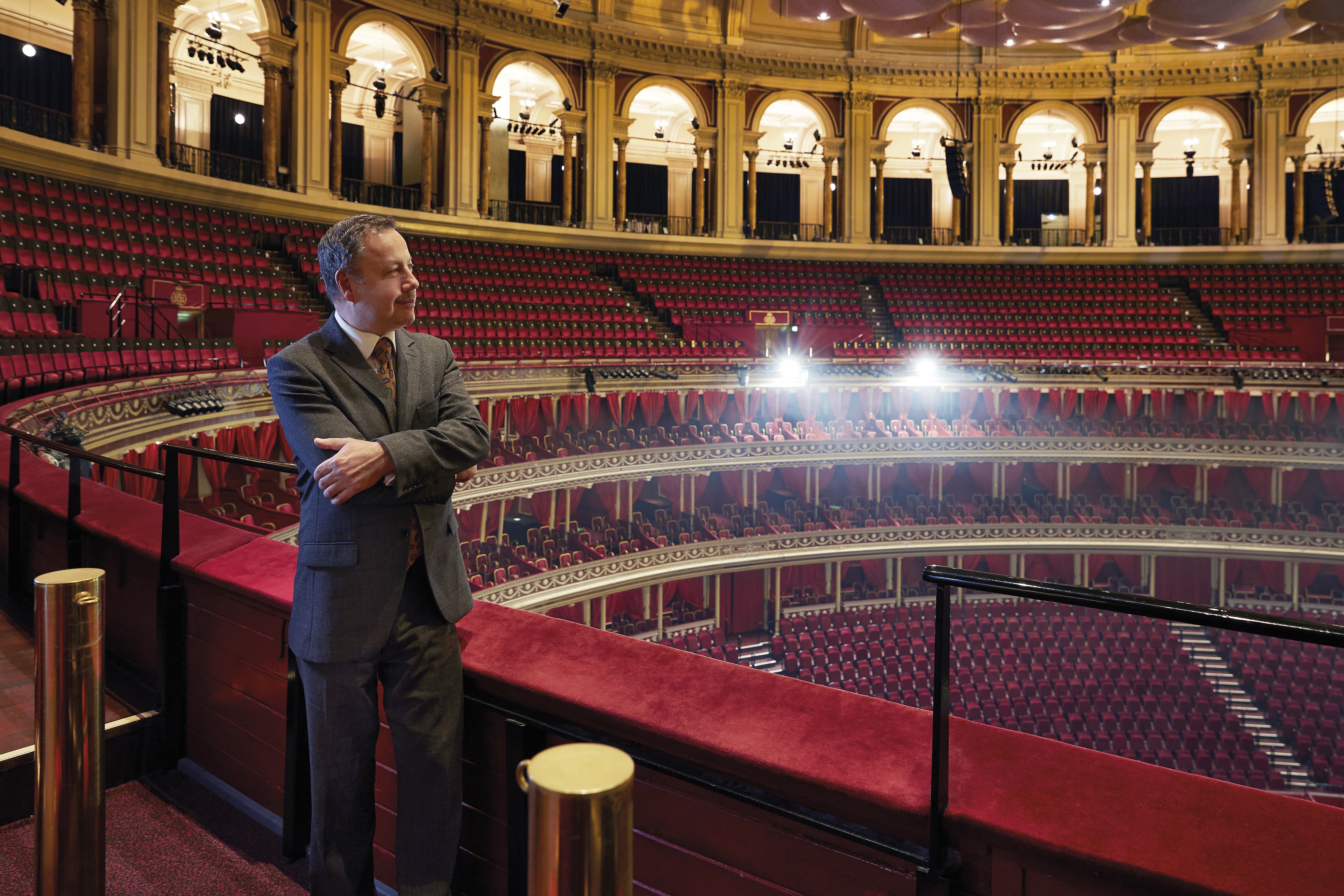 man standing in the amphitheatre stalls of the Royal Albert Hall