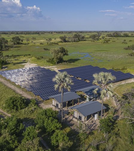 Solar panels on the Okavango Delta surrounded by bush and trees Solar panels on the Okavango Delta surrounded by bush and trees