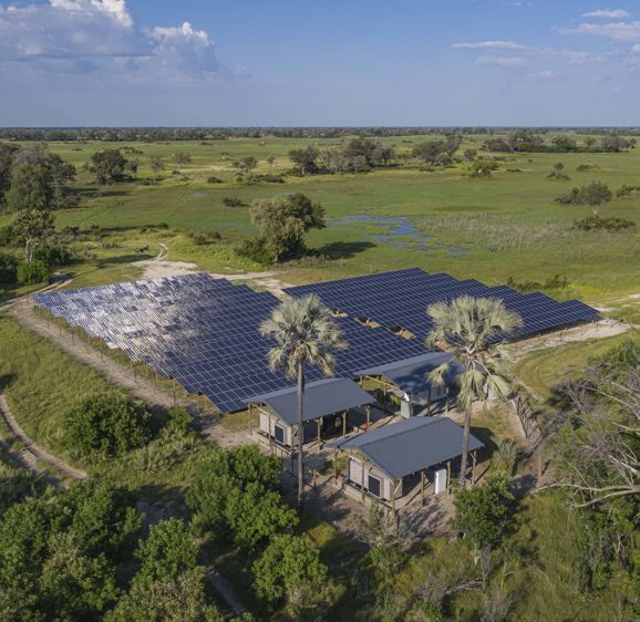 Solar panels on the Okavango Delta surrounded by bush and trees Solar panels on the Okavango Delta surrounded by bush and trees