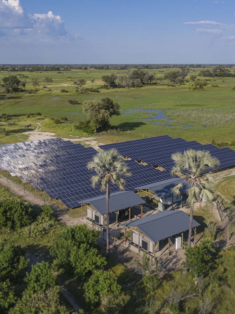 Solar panels on the Okavango Delta surrounded by bush and trees Solar panels on the Okavango Delta surrounded by bush and trees