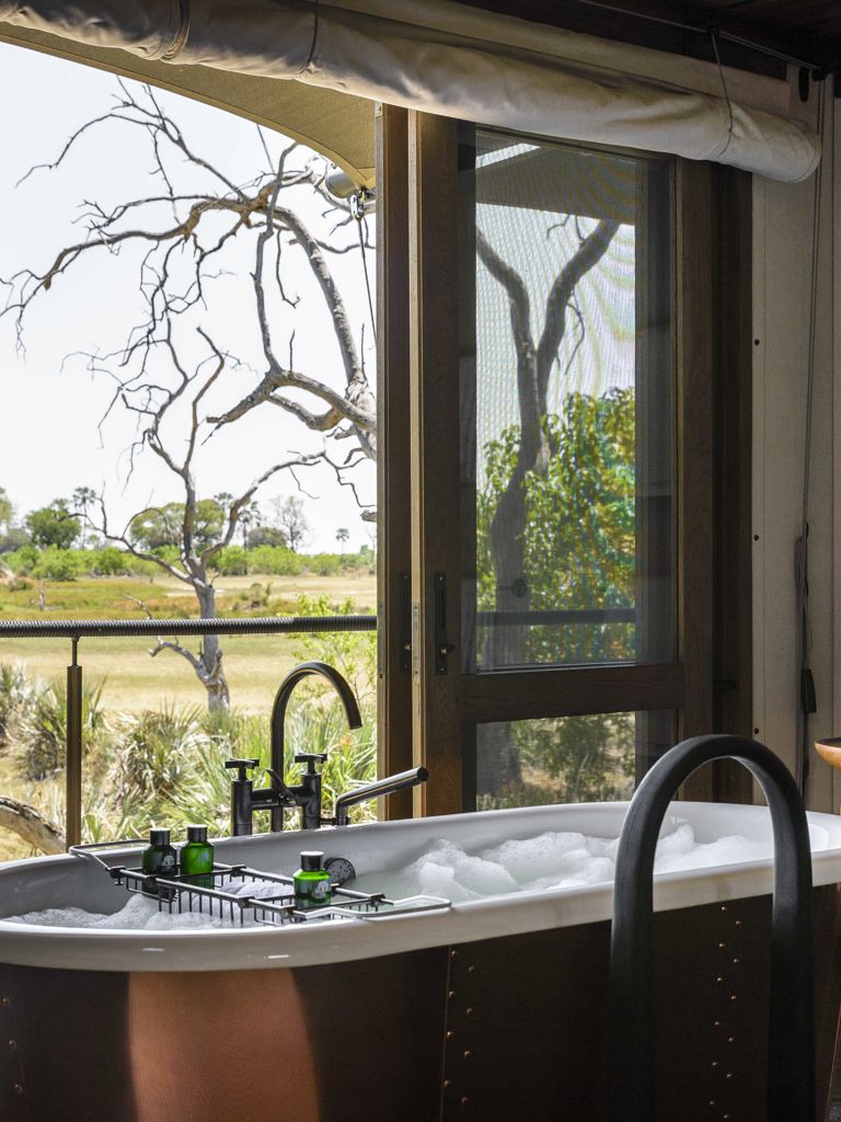 Xigera suite bath looking out on to the grass plains Xigera suite bath looking out on to the grass plains