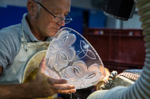 Waterford Crystal glassmaker checking his glass bowl
