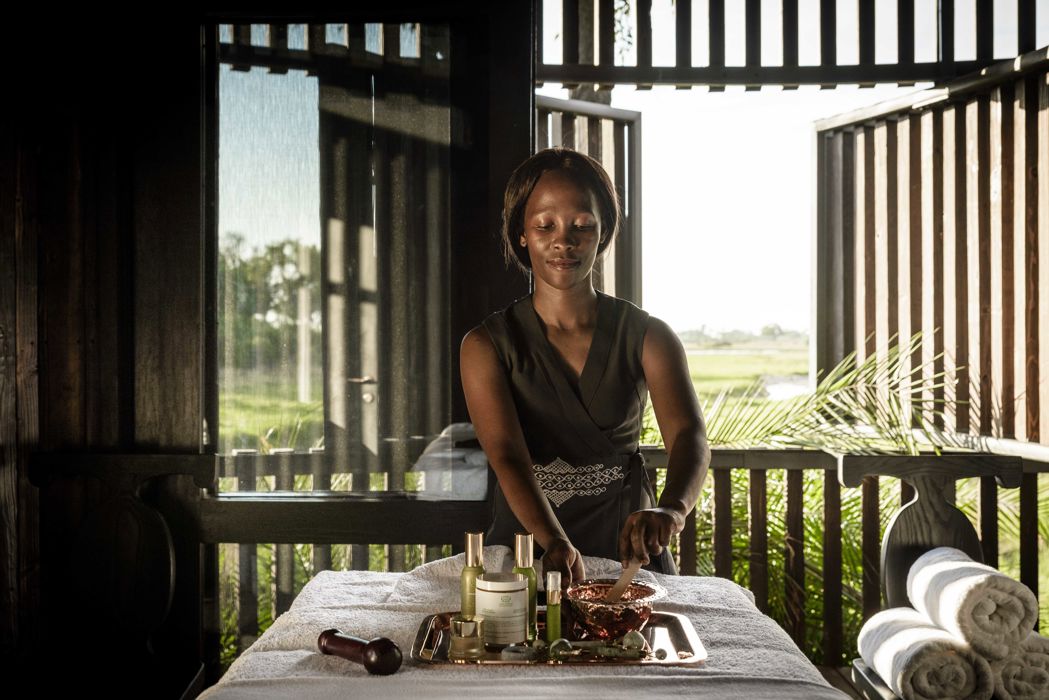 Spa therapist laying out oils