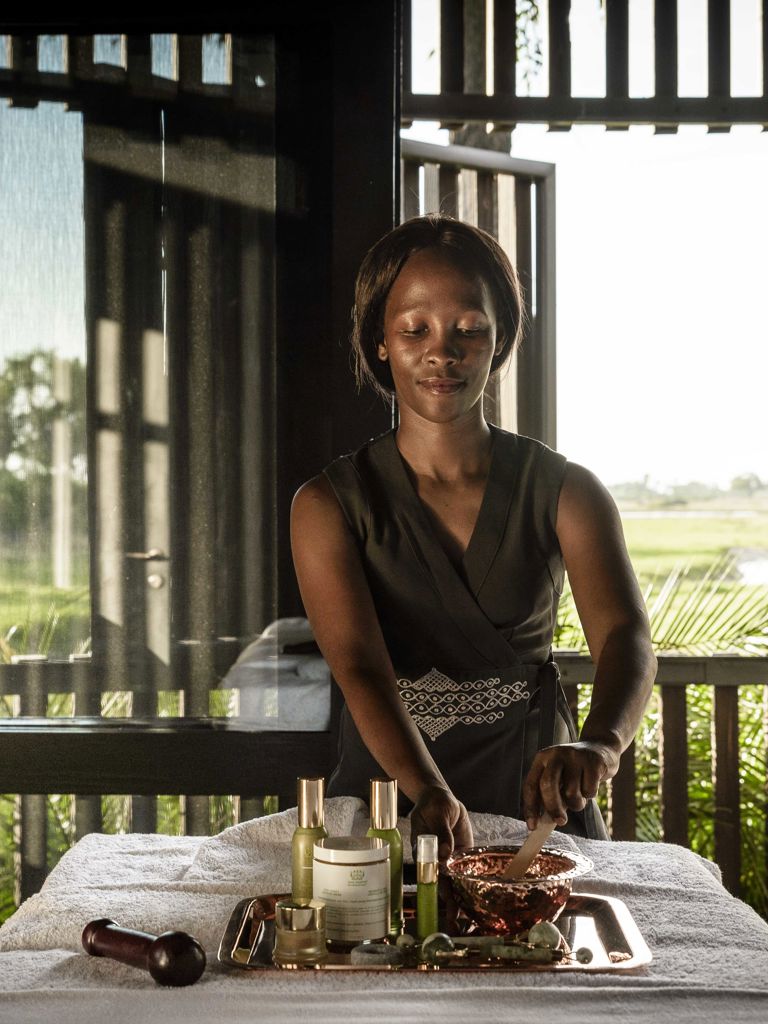 Spa therapist laying out oils Spa therapist laying out oils