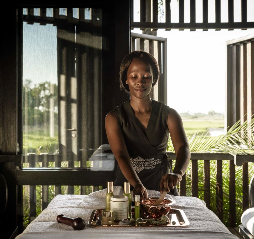 Spa therapist laying out oils Spa therapist laying out oils