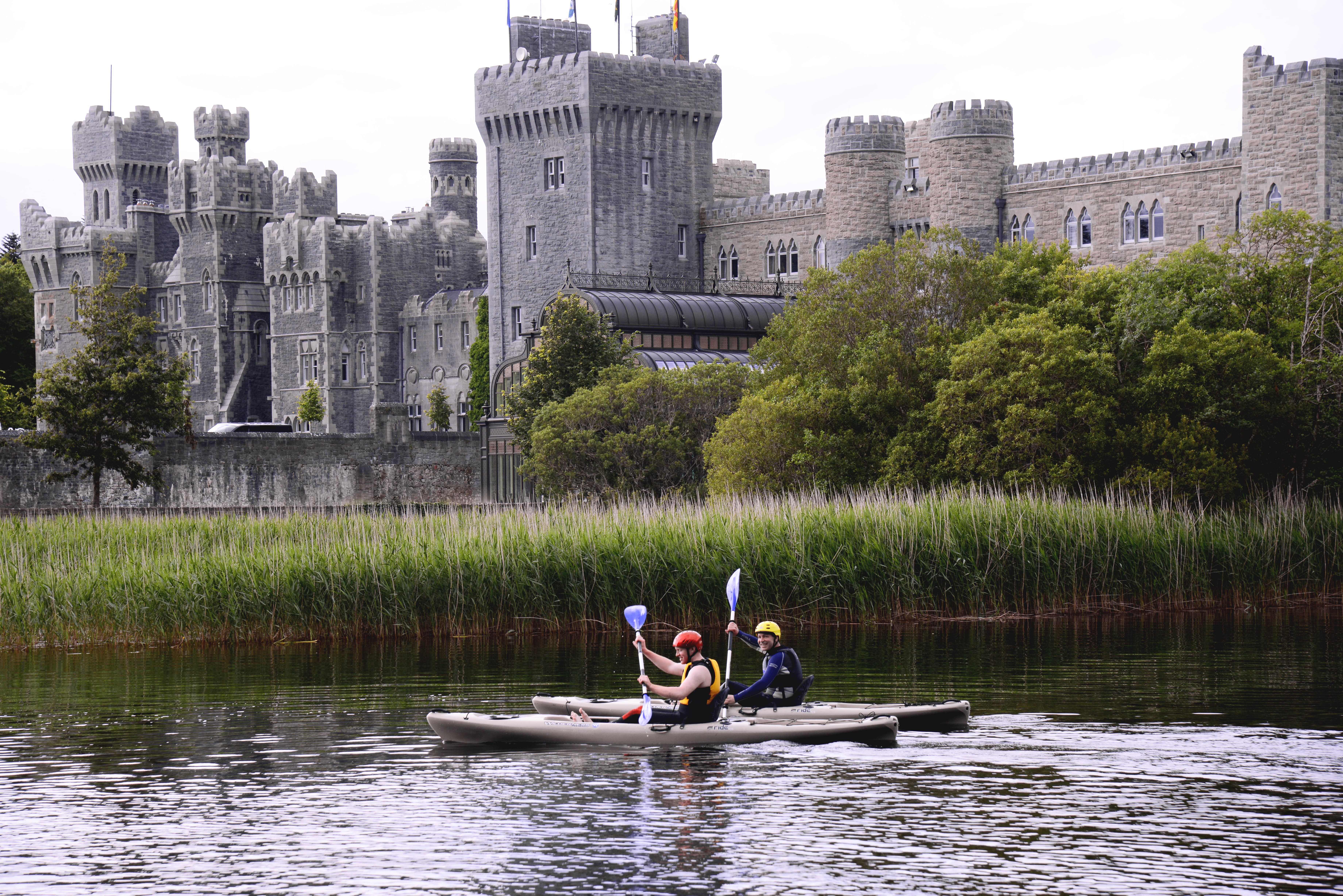 Guests kayaking on Ashford Castle grounds