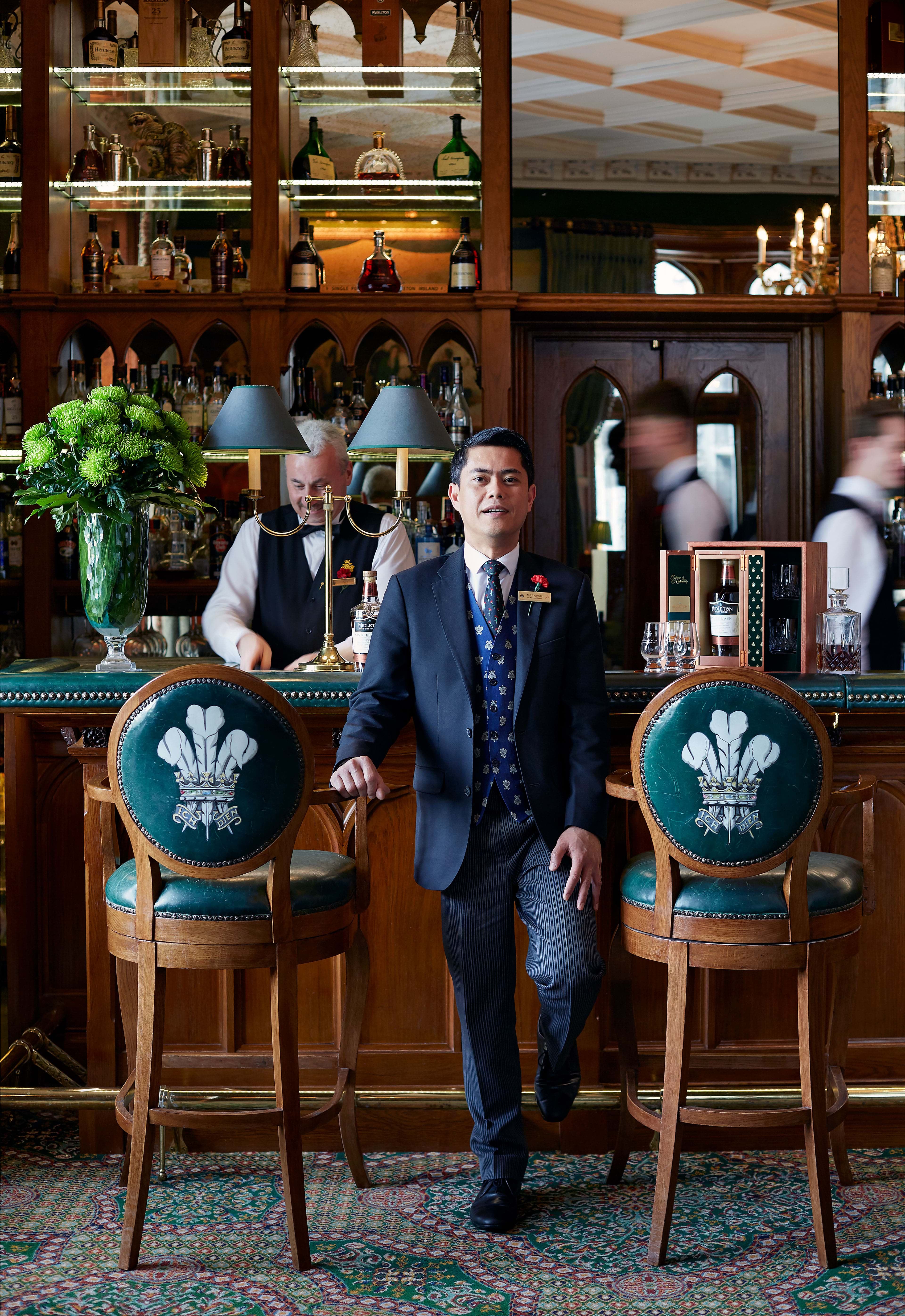 Noli Alngohuro In Prince Of Wales Bar with barmen in the background