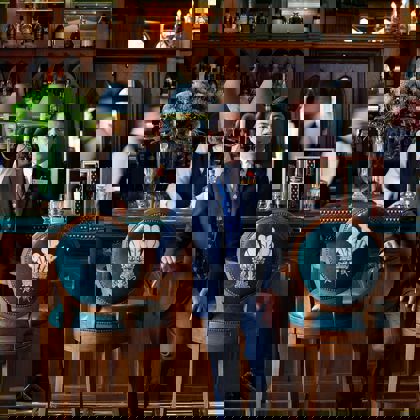 Noli Alngohuro In Prince Of Wales Bar with barmen in the background Noli Alngohuro In Prince Of Wales Bar with barmen in the background