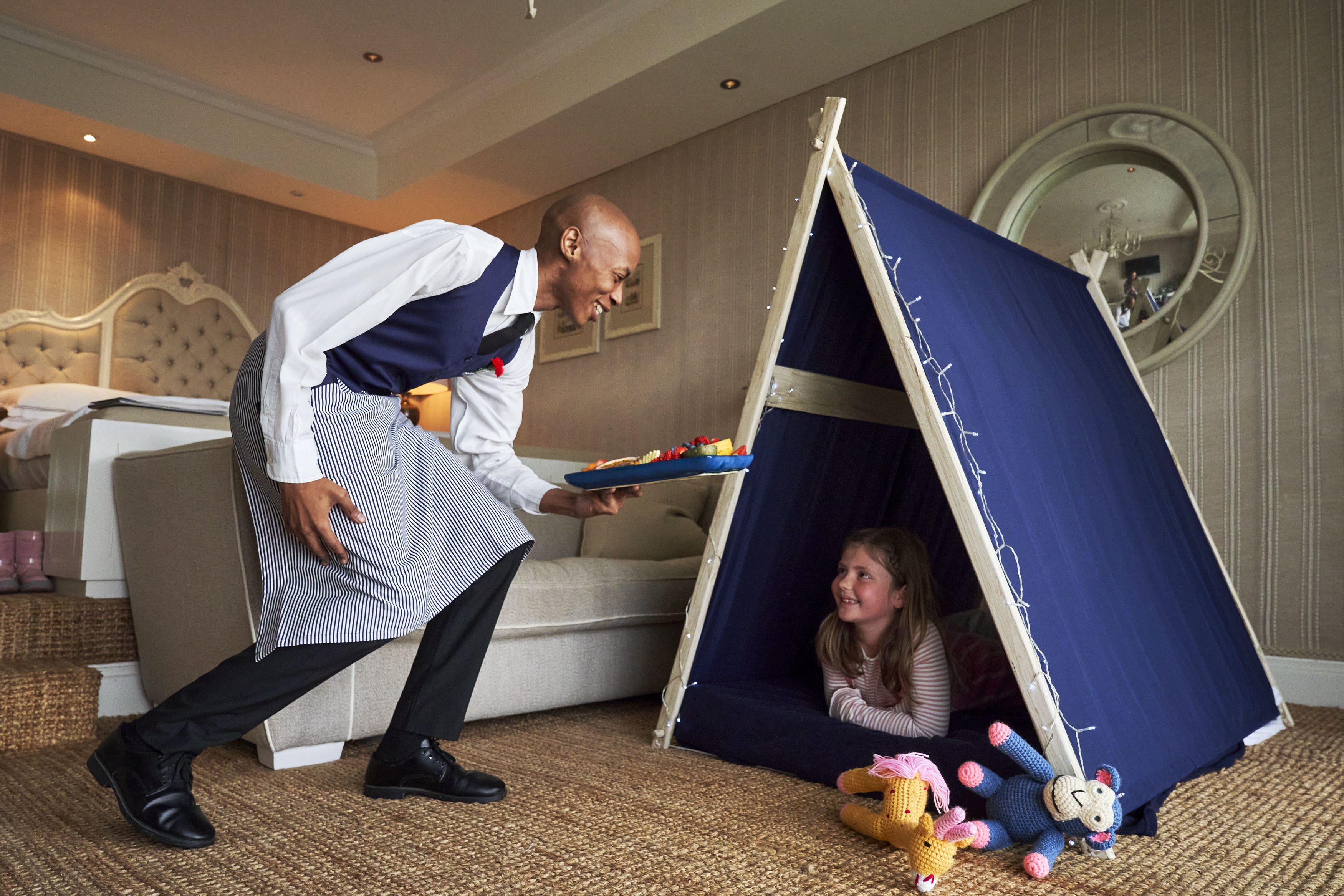 Girl in Wigwam being served fruit