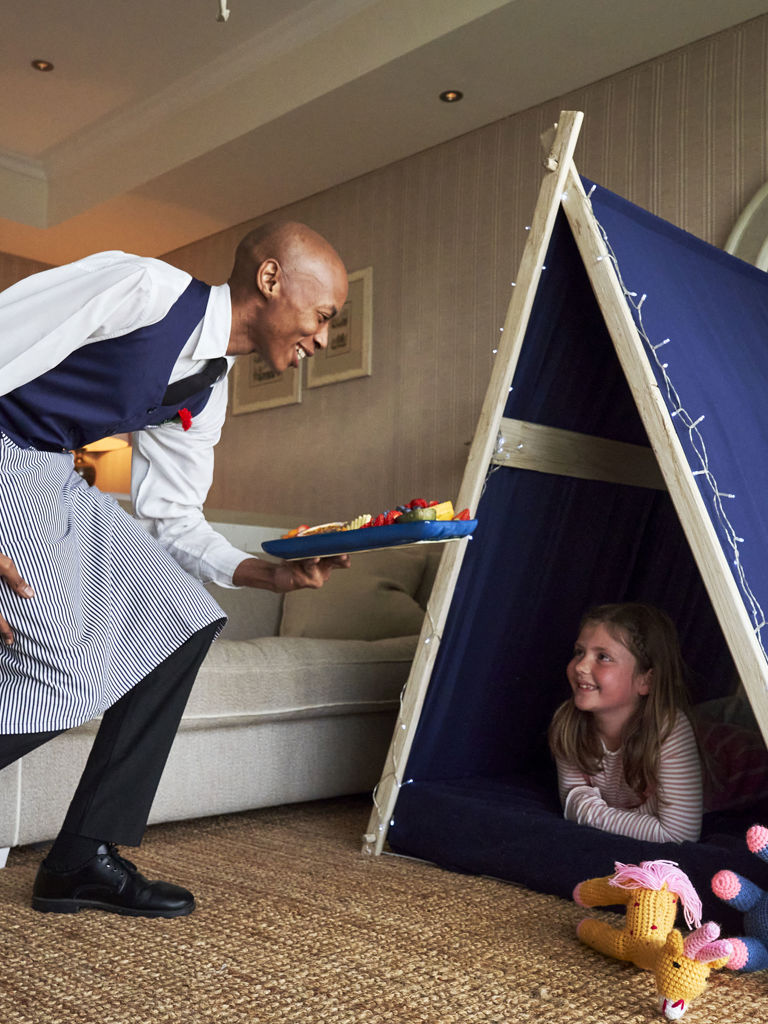 Girl in Wigwam being served fruit Girl in Wigwam being served fruit