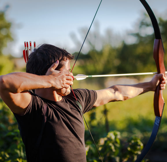 Young archer training with the bow Young archer training with the bow