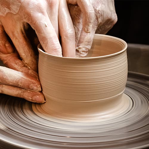 Spinning wet pottery on a pottery wheel