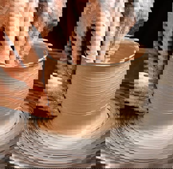 Spinning wet pottery on a pottery wheel Spinning wet pottery on a pottery wheel