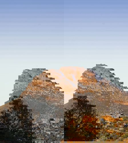 Hikers at the top of a hill viewing the surrounding Cederburg mountains Hikers at the top of a hill viewing the surrounding Cederburg mountains