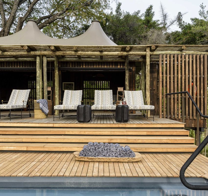 swimming pool, with deck chairs and towels layed out swimming pool, with deck chairs and towels layed out