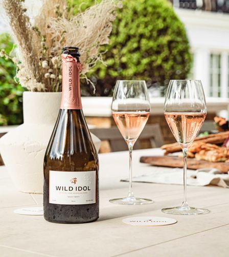 Bottle and poured glasses of Wild Idol alcohol-free sparkling rosé Bottle and poured glasses of Wild Idol alcohol-free sparkling rosé