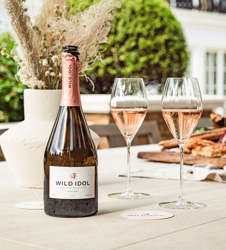 Bottle and poured glasses of Wild Idol alcohol-free sparkling rosé Bottle and poured glasses of Wild Idol alcohol-free sparkling rosé
