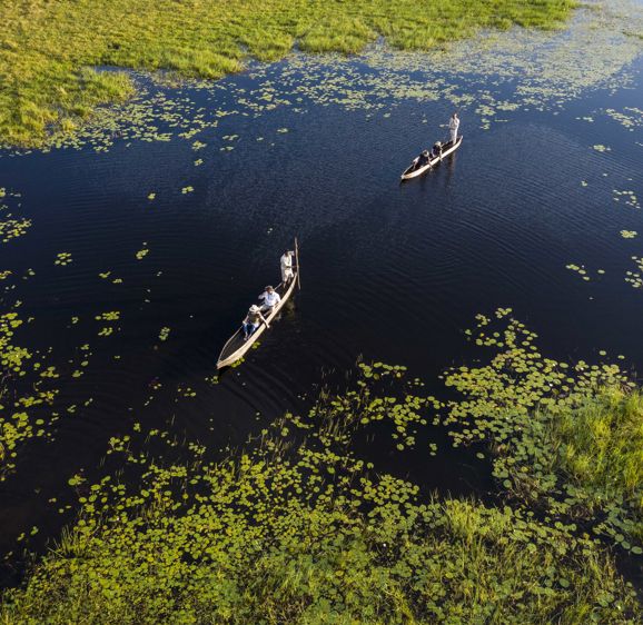 Mokoro Boat people on a water tour Mokoro Boat people on a water tour
