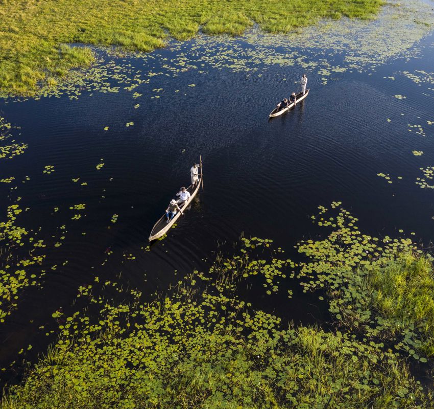 Mokoro Boat people on a water tour Mokoro Boat people on a water tour