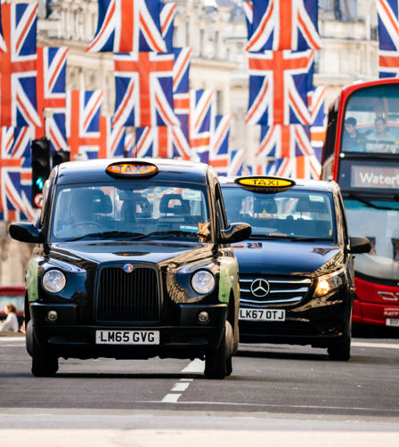 Taxi cabs and buses under Union Jack Flags on Regent Street Taxi cabs and buses under Union Jack Flags on Regent Street