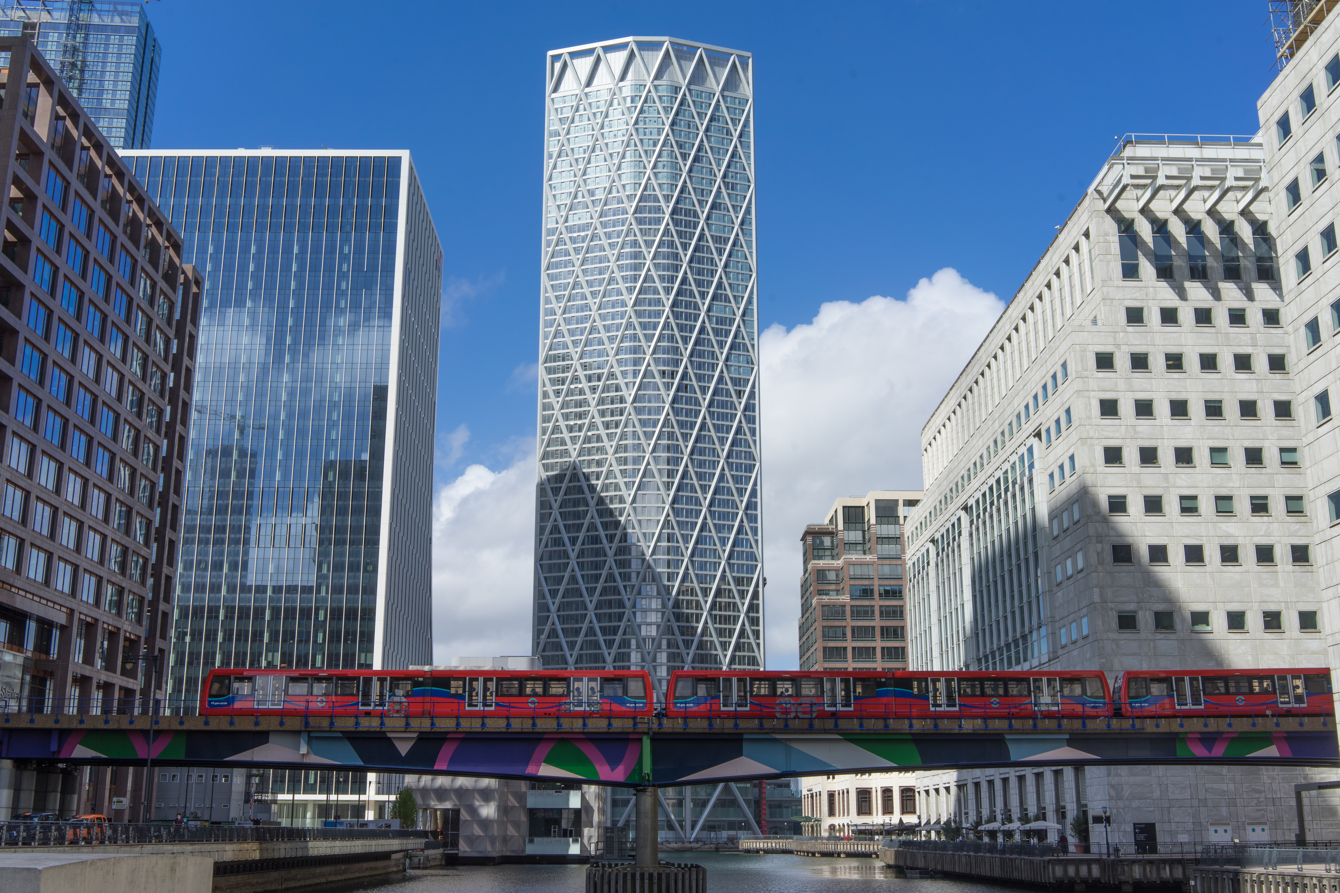 Skyscraper in Canary Wharf with a Docklands Light Railway train below