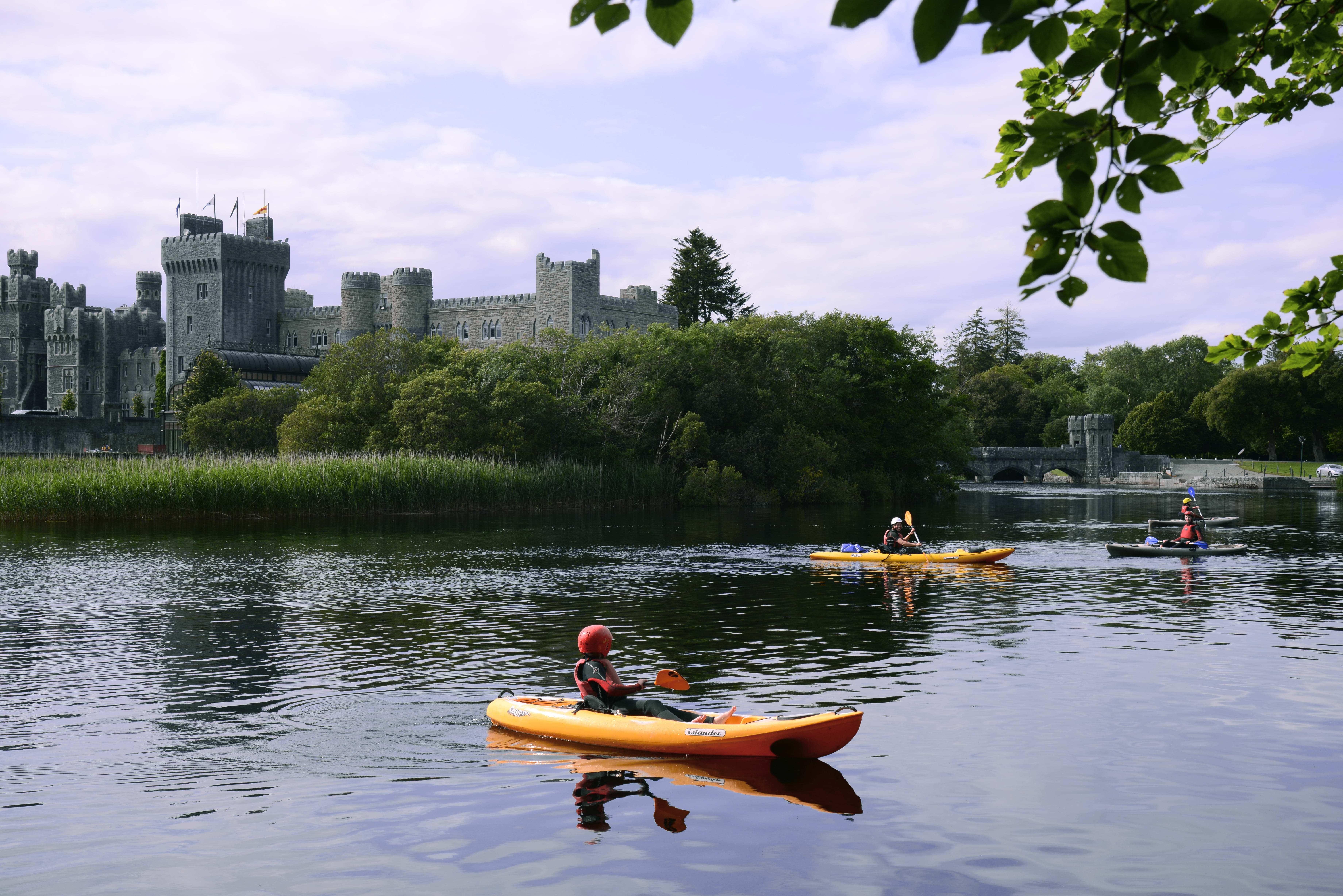 Guests kayaking on Ashford Castle grounds
