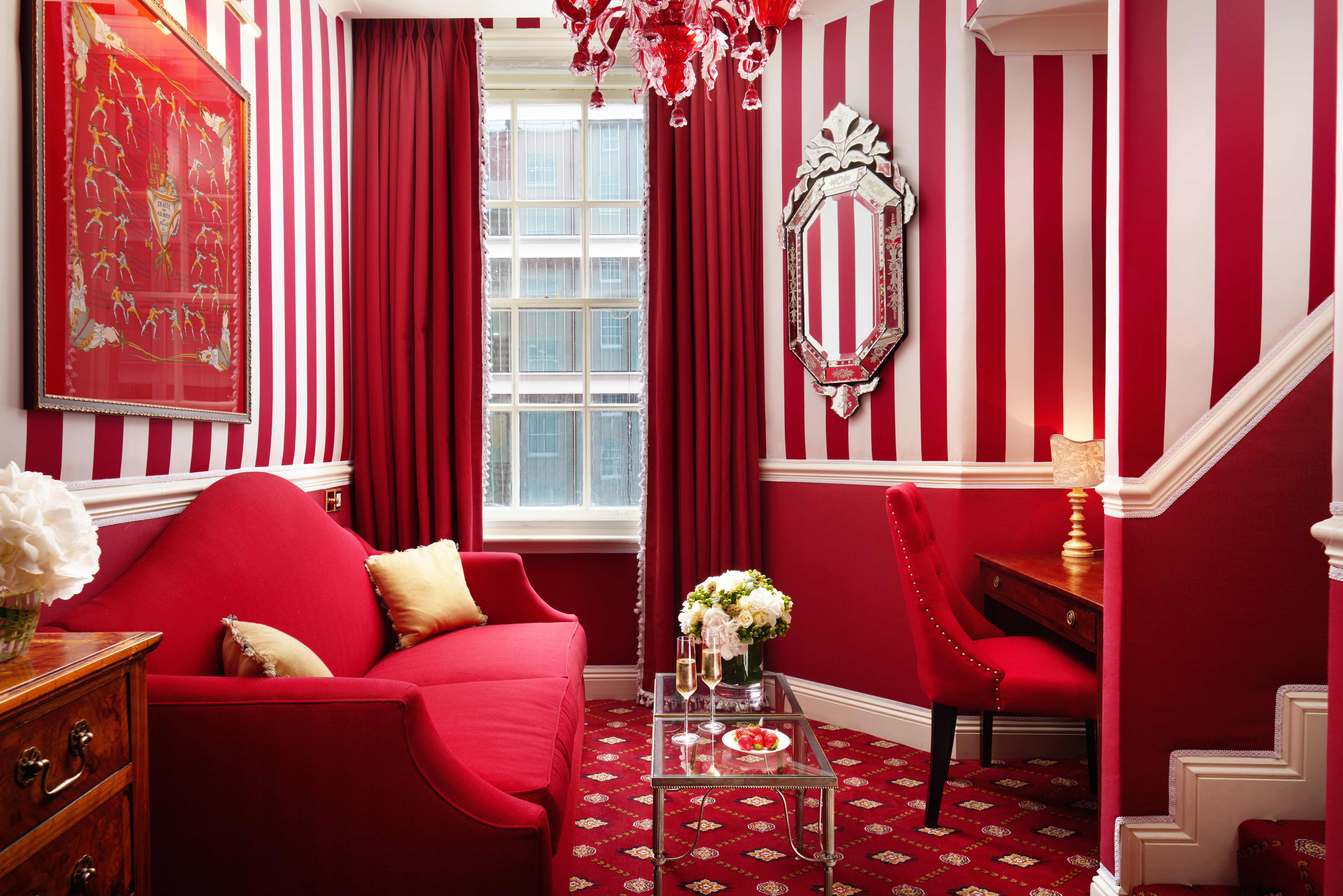 Red sofa in the Executive King Room at the Rubens