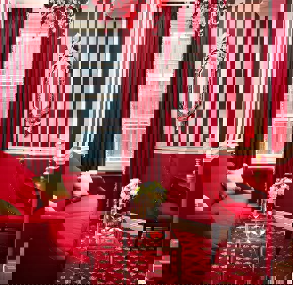 Red sofa in the Executive King Room at the Rubens Red sofa in the Executive King Room at the Rubens