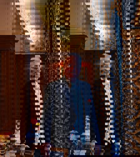 Robert Bowe standing in the restaurant in front of a drape Robert Bowe standing in the restaurant in front of a drape