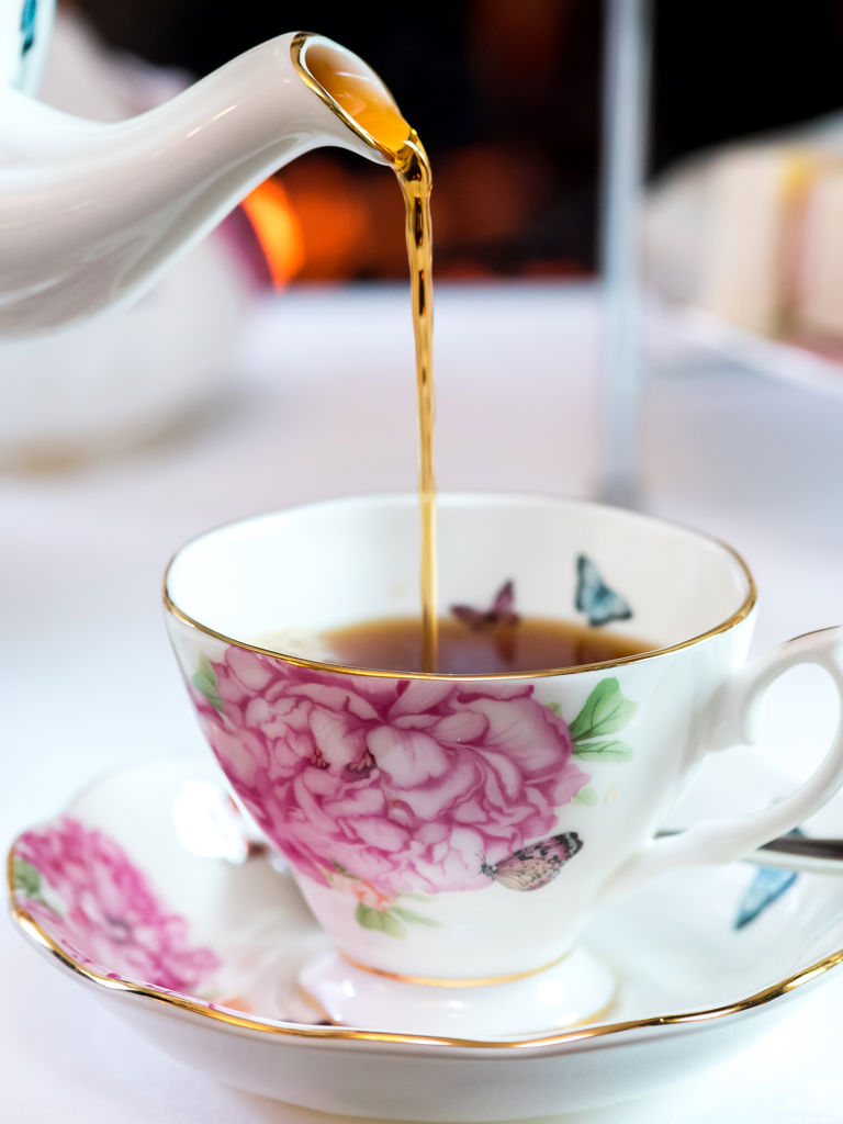 Photo of tea being poured into tea cup Photo of tea being poured into tea cup