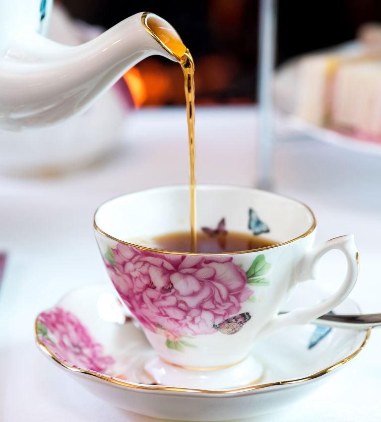 Photo of tea being poured into tea cup Photo of tea being poured into tea cup