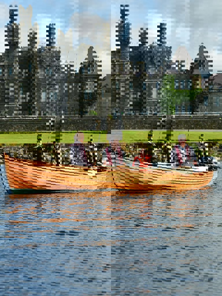 Family fishing on a boat at Ashford Castle Family fishing on a boat at Ashford Castle