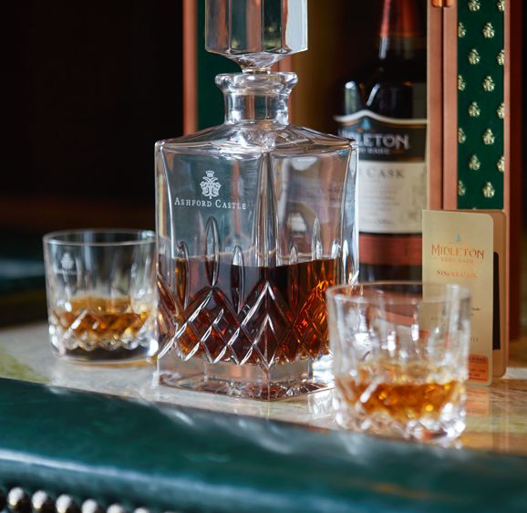 Midleton Whiskey on the bar counter in crystal glasses Midleton Whiskey on the bar counter in crystal glasses