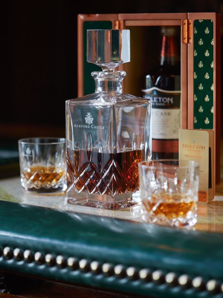 Midleton Whiskey on the bar counter in crystal glasses Midleton Whiskey on the bar counter in crystal glasses