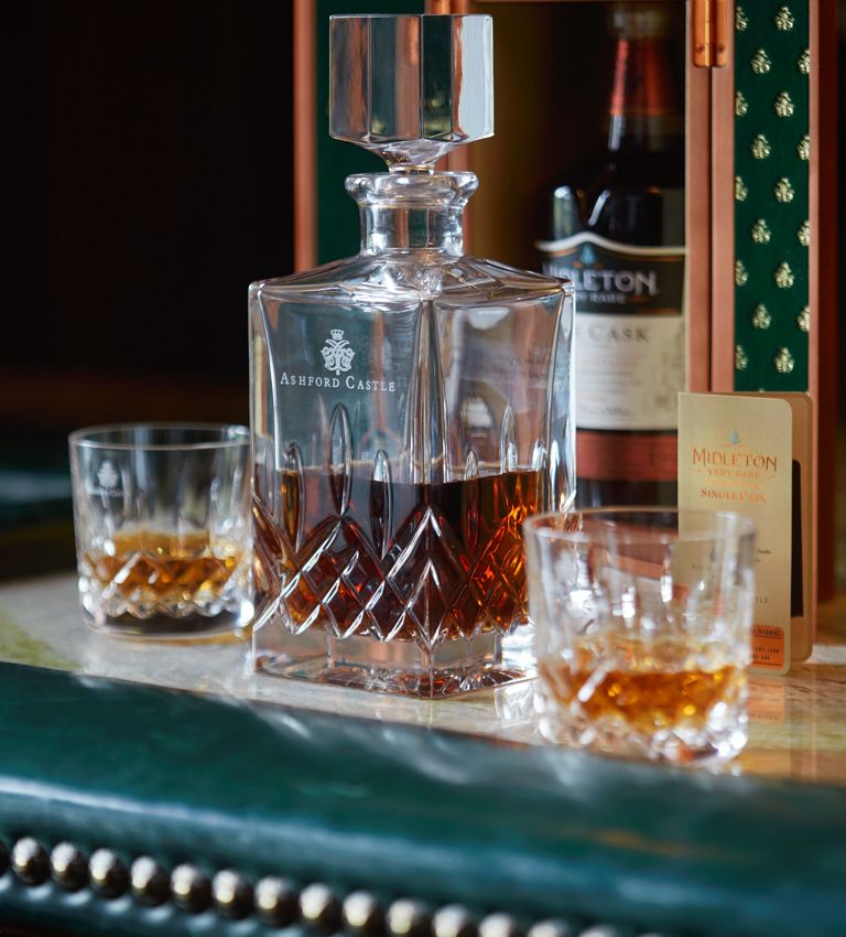 Midleton Whiskey on the bar counter in crystal glasses Midleton Whiskey on the bar counter in crystal glasses