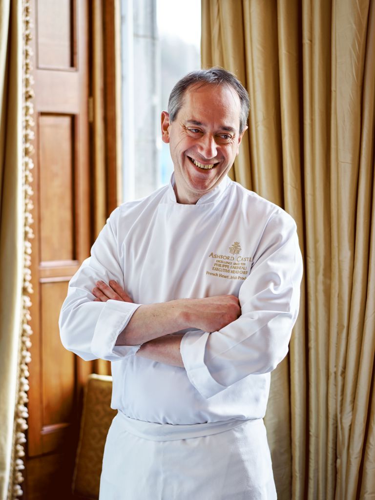 Executive Chef Philippe Farineau standing in front of a window with a drape in the background Executive Chef Philippe Farineau standing in front of a window with a drape in the background