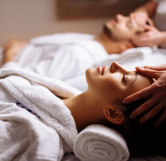 Young couple receiving head massage at beauty spa  Young couple receiving head massage at beauty spa