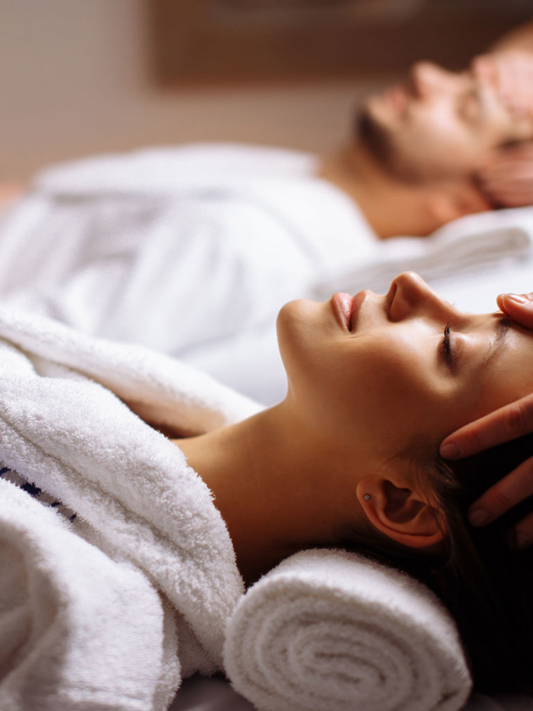 Young couple receiving head massage at beauty spa  Young couple receiving head massage at beauty spa