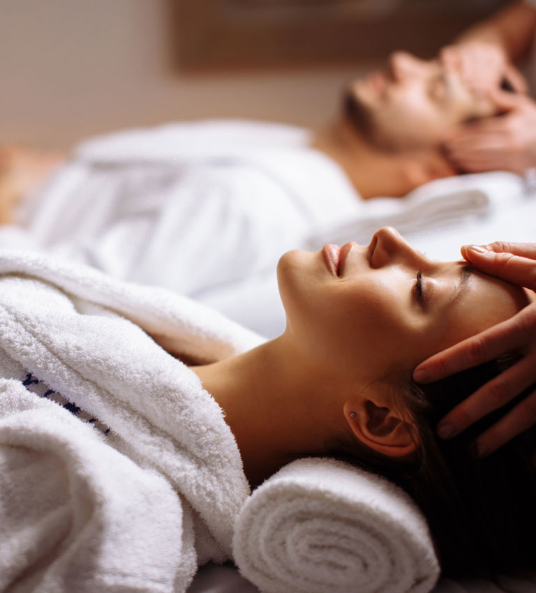 Young couple receiving head massage at beauty spa Young couple receiving head massage at beauty spa