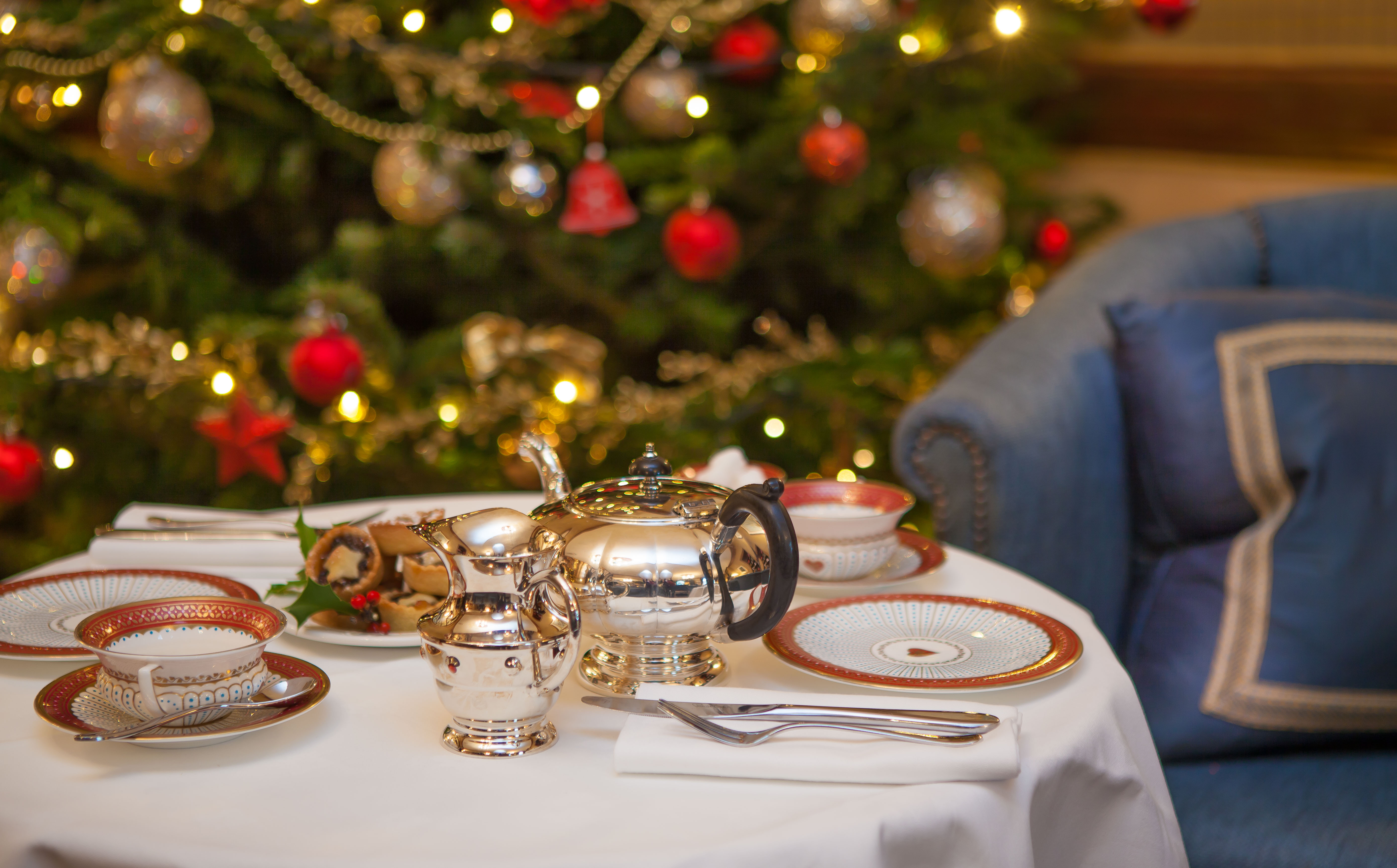 Tea and mince pies in front of a Christmas Tree