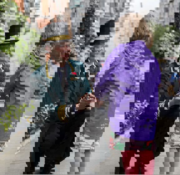 Milestone Concierge greeting a younger guest outside of the hotel Milestone Concierge greeting a younger guest outside of the hotel